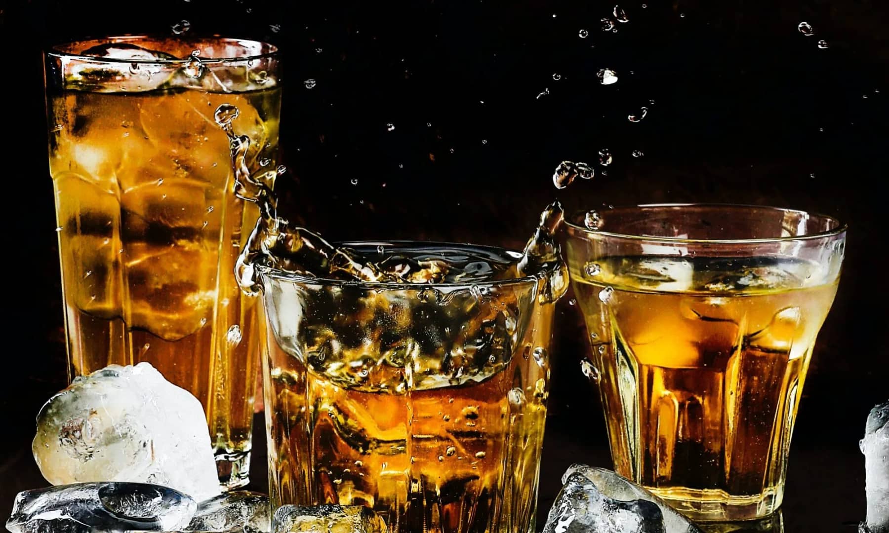 Three crystal glasses filled with whiskey on the rocks